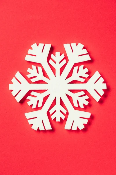 Top view of paper snowflake on red background — Stock Photo