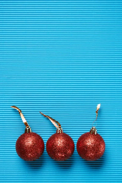 Top view of red shiny decorative christmas balls on the blue background — Stock Photo