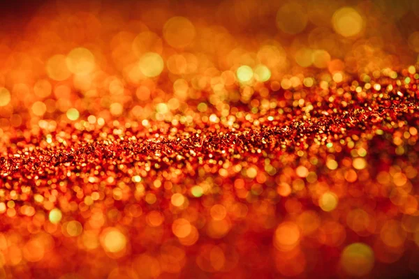 Sfondo lucido astratto con glitter rosso sfocato — Foto stock