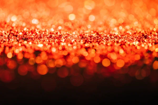 Glowing christmas texture with red defocused glitter — Stock Photo