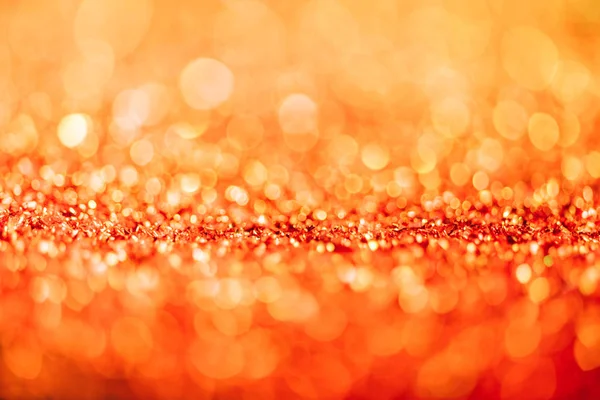 Abstract christmas background with orange glitter and bokeh — Stock Photo