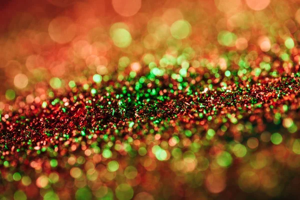 Glowing christmas texture with colorful blurred glitter — Stock Photo