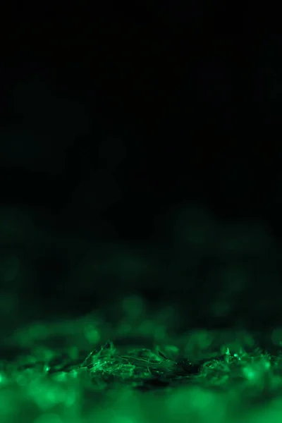 Green glitter on black background with copy space — Stock Photo