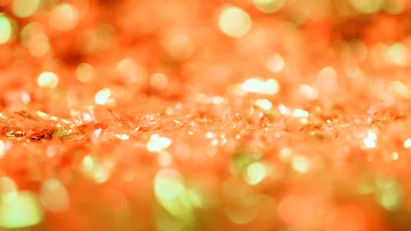 Fond lumineux abstrait avec paillettes orange et bokeh — Photo de stock