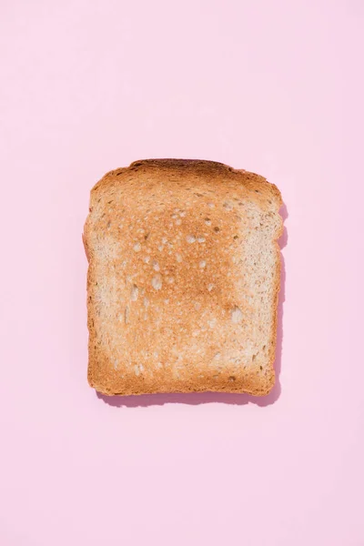 Top view of crunchy toast on pink surface — Stock Photo