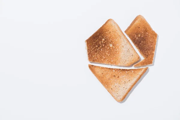 Top view of heart shape made of toast on white surface — Stock Photo