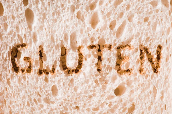 Close-up shot of slice of bread with burned gluten sign — Stock Photo