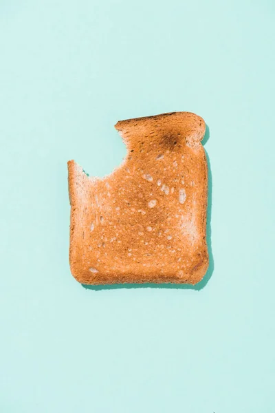 Vista dall'alto del pane tostato croccante morso sulla superficie blu — Foto stock