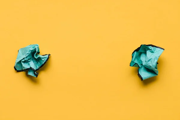 Top view of crumpled paper balls with copy space on yellow background, think different concept — Stock Photo