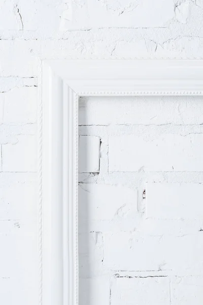 Close up view of white empty frame hanging on brick wall — Stock Photo