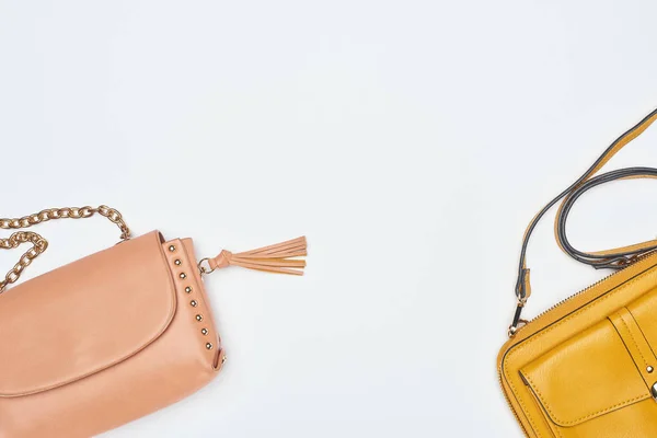 Pink and yellow bags on white background — Stock Photo