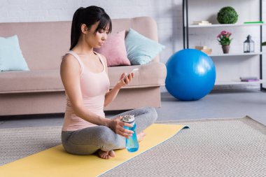 yoga mat egzersiz yaptıktan sonra rahatlatıcı ve istimal smartphone vasıl ev güzel ve genç birbayan
