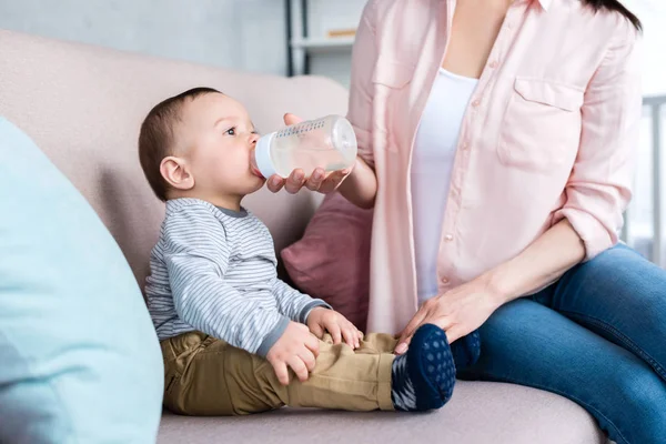 Cropped Shot Mother Feeding Her Little Child Bottle Home — Stock Photo, Image