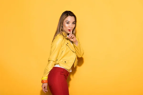Attractive Asian Female Model Closing Mouth Finger Yellow Background — Stock Photo, Image
