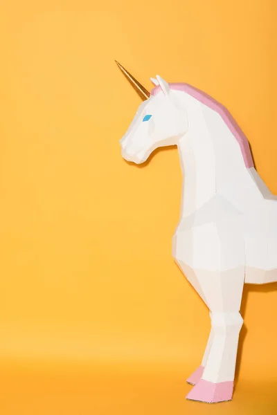 stock image partial view of decorative unicorn standing on yellow background 