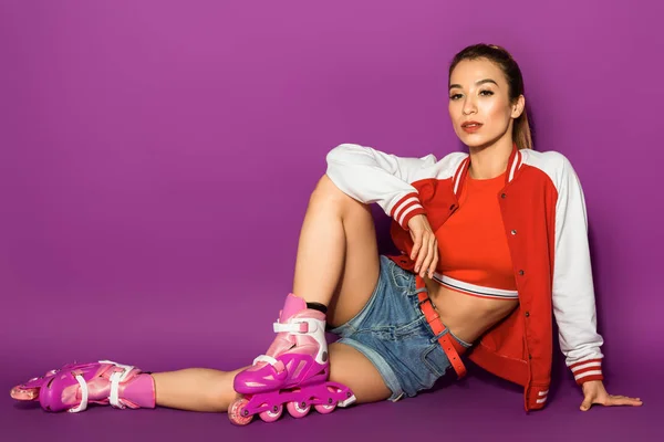 Beautiful Asian Girl Roller Skates Sitting Looking Camera Isolated Violet — Stock Photo, Image