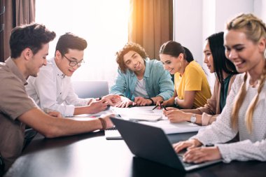 modern ofis grafikleriyle masada tartışma iş meslektaşlarının çok ırklı Grup 