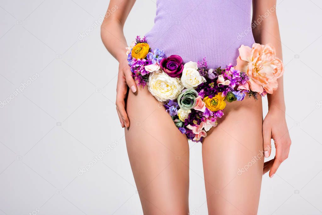 cropped shot of girl in panties made of beautiful tender flowers isolated on grey 