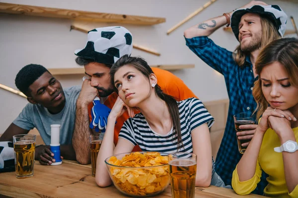 Upset Group Multiethnic Friends Soccer Ball Hats Watching Football Match — Free Stock Photo