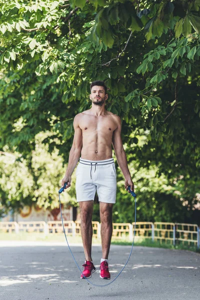 Sporty Shirtless Young Man Working Out Jumping Rope — Free Stock Photo