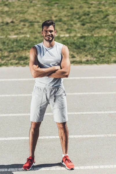 Smiling Sporty Young Man Crossed Arms Looking Camera Running Track — Stock Photo, Image