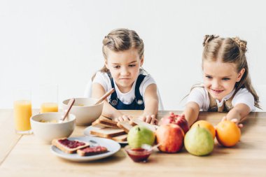 little sisters do not want to eat healthy breakfast isolated on white clipart