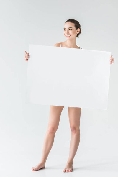 happy young woman holding blank banner isolated on gray background 