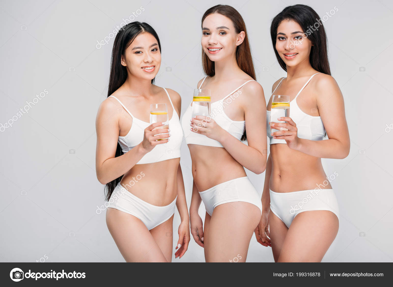 Women In White Underwear Holding Glasses Of Water With Lemon Stock