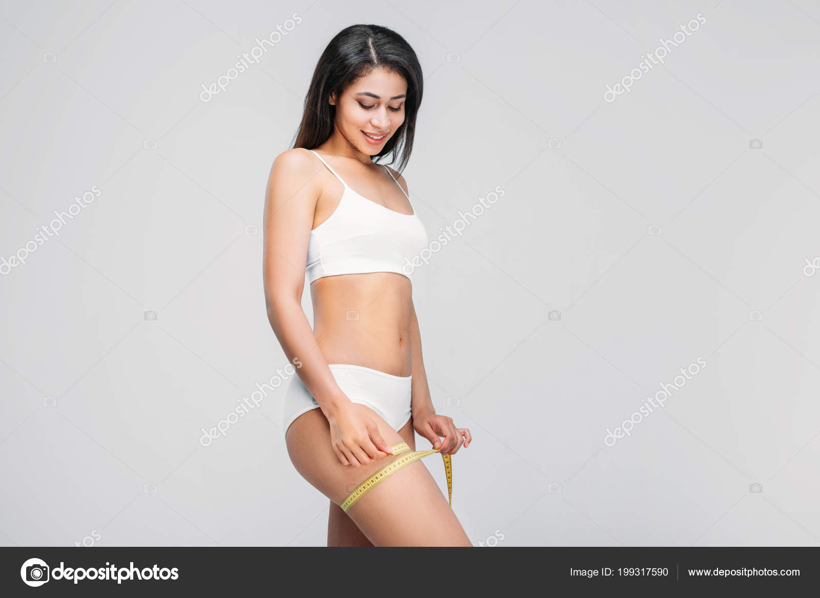 Beautiful Slim African American Girl Underwear Measuring Her Leg