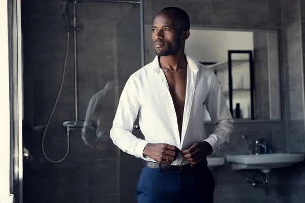 Thoughtful Businessman Buttoning His White Shirt Bathroom Looking Away — Stock Photo, Image