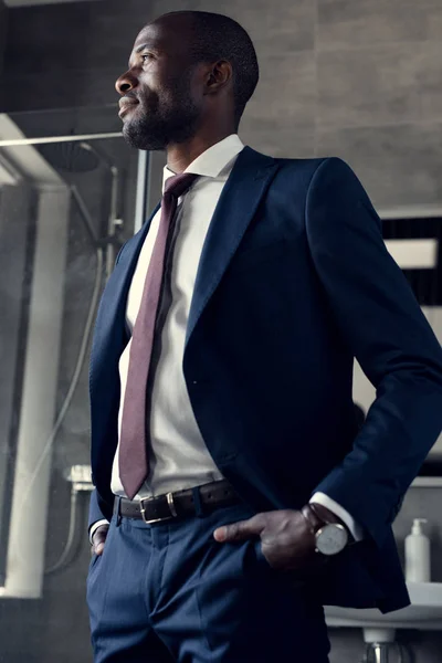 Young Businessman Stylish Suit Standing Bathroom Looking Away — Stock Photo, Image
