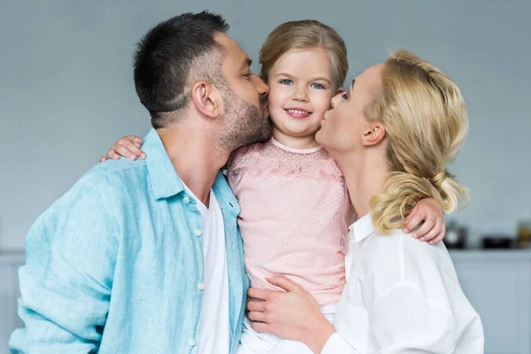 Happy Parents Kissing Adorable Little Daughter Home — Stock Photo, Image