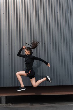 şehirde atlama siyah sportif termal giysili genç sporcumuz
