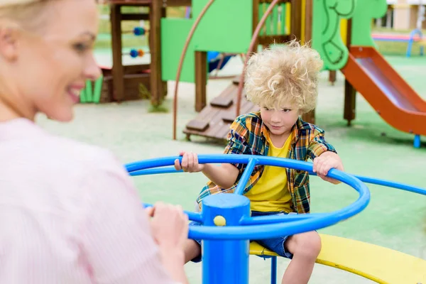 Selective Focus Curly Little Boy Riding Mother Carousel Playground — Stock Photo, Image
