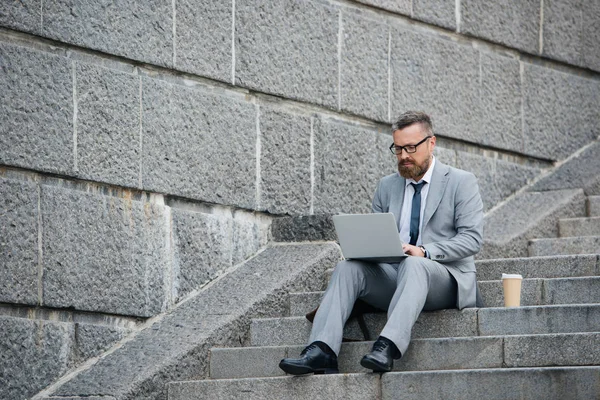 Bearded Businessman Using Laptop Sitting Stairs Coffee — Free Stock Photo