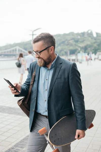 Όμορφος Γενειοφόρος Άνδρας Longboard Χρησιμοποιώντας Smartphone Στην Πόλη — Φωτογραφία Αρχείου