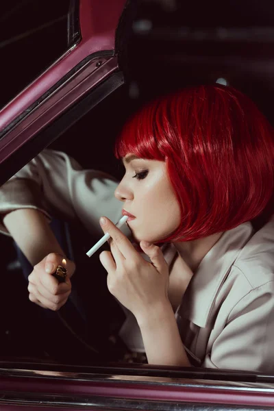 Zijaanzicht Van Mooie Jonge Vrouw Rode Pruik Roken Sigaret Auto — Stockfoto