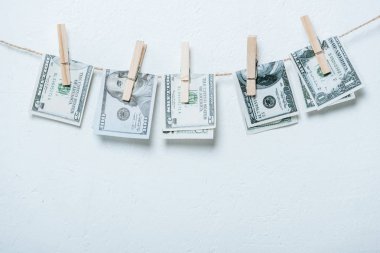 dollar banknotes hanging on rope isolated on grey clipart