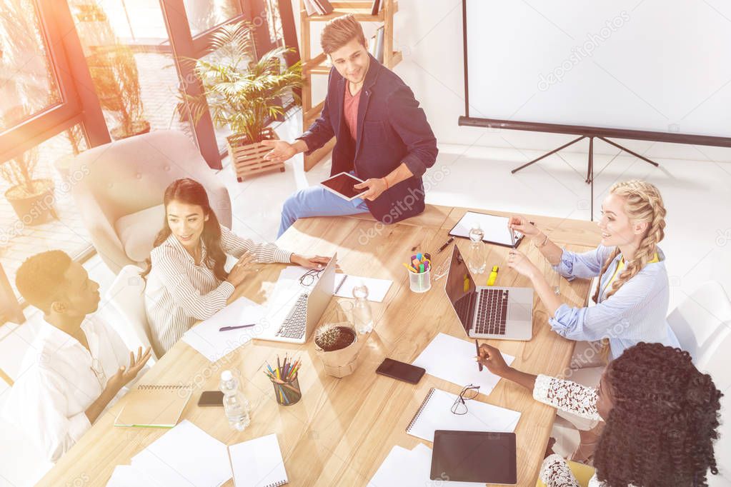 high angle view of multicultural business team having meeting in office