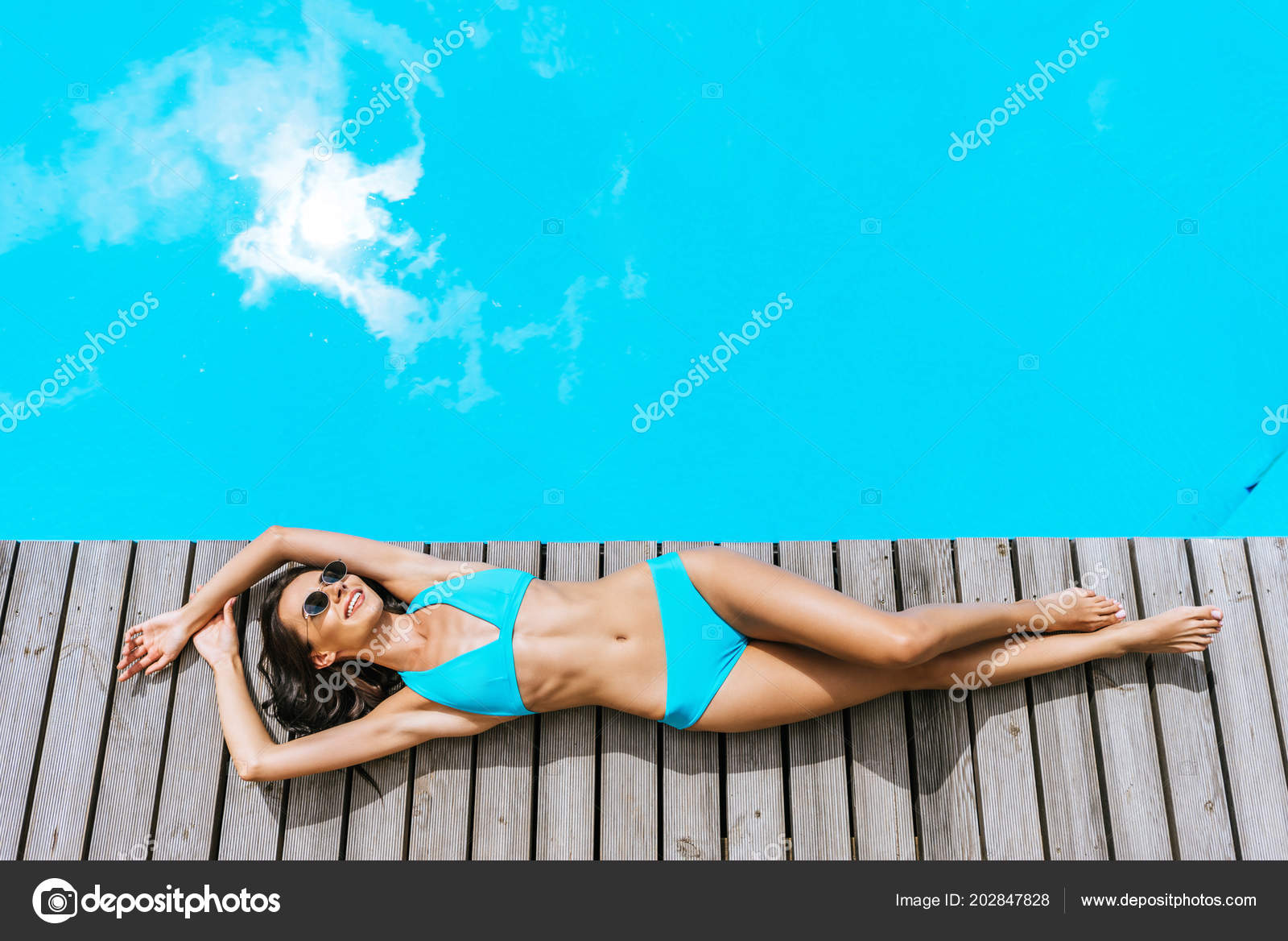Foto de Brunette woman in bra and panties underwater. do Stock
