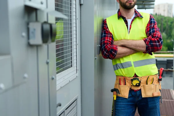 Beskuren Bild Ingenjör Säkerhetsväst Med Verktygsbälte Poserar Med Korsade Armar — Stockfoto