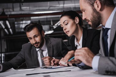 planları ile birlikte çalışan mühendis meslektaşları resmi giyim