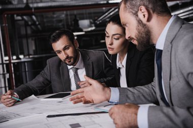 mimar ve mühendisler elbiseli inşaat planları ile birlikte çalışma