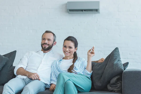 Happy Couple Turning Air Conditioner Remote Control Summer Heat Home — Stock Photo, Image