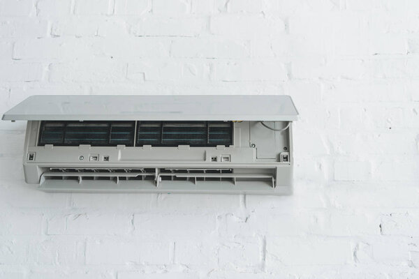 opened air conditioner on white wall at home
