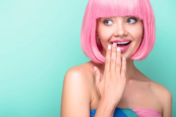 若い女性を浮かべてターコイズに分離の手で口を覆っているピンクのボブ カット — ストック写真