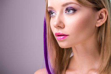 close-up portrait of beautiful young woman with colorful strands in hair looking away clipart
