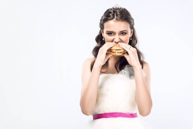 attractive hungry young bride in wedding dress eating hamburger isolated on white clipart