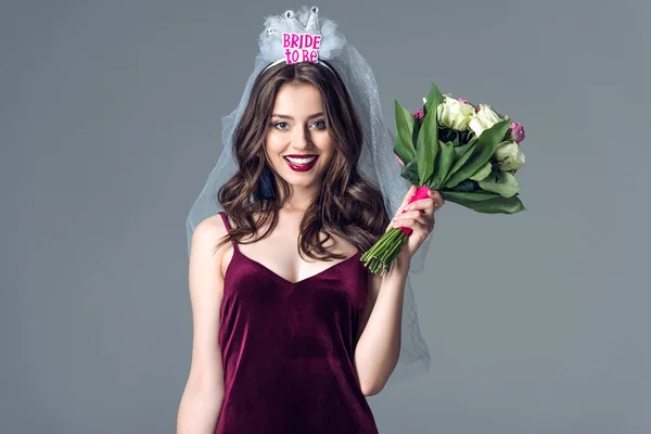 Smiling future bride in veil for bachelorette party with bouquet looking at camera isolated on grey — Stock Image Smiling Future Bride Veil Bachelorette Party Bouquet Looking Camera Isolated Stock Picture