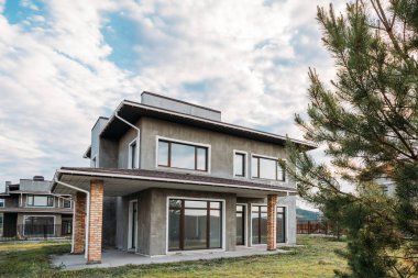 modern concrete building under cloudy sky clipart